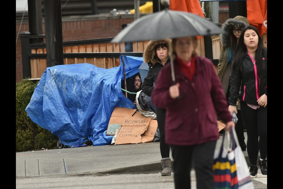 Denis Quesnel, 34, was living under a tarp at Cambie and Broadway Wednesday morning. He was expected to be counted in the city’s annual homeless count, which began Tuesday. Photo Dan Toulgoet