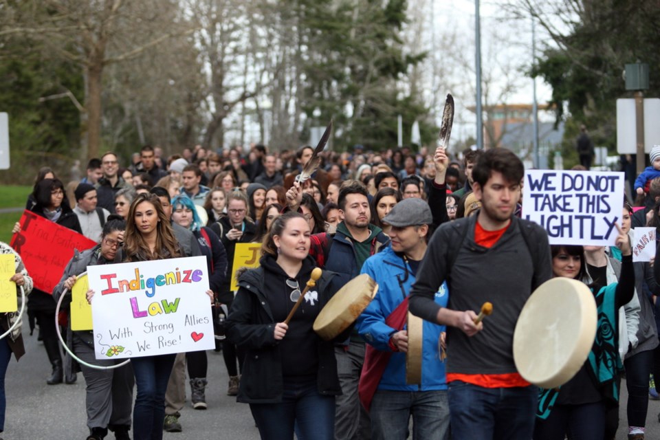 Students stage a walkout to raise awareness about systemic discrimination in the Canadian justice system during a protest at the University of Victoria on Wednesday, March 14, 2018.