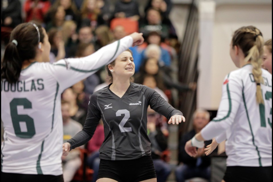 Douglas College libero and captain Claudia Corneil, centre, celebrates a point during the semifinal win over Humber, with teammates Vania Oliveira, at left, and Jane Kepler at last week’s CCAA national women’s volleyball championships in Grande Prairie, Alta.