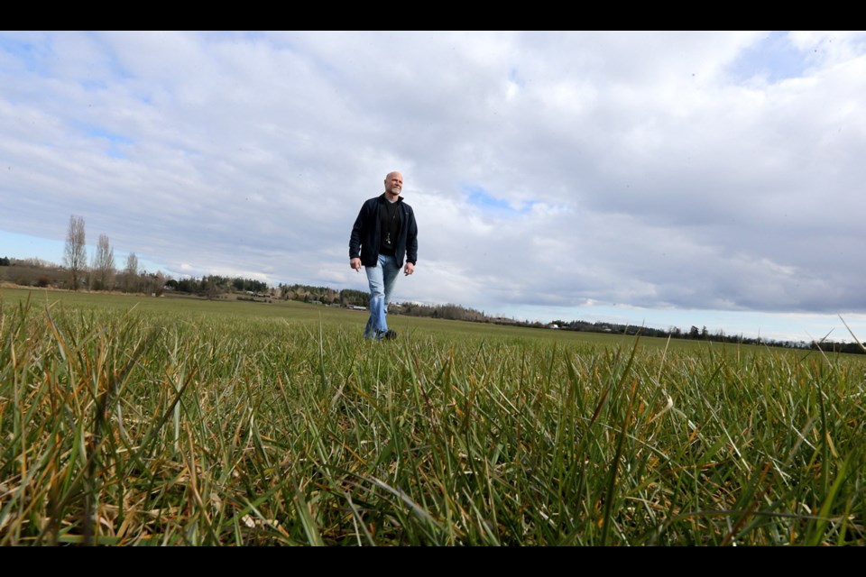 Shawn Galbraith, CEO of Evergreen Medicinal Supply, walks through the open field at the 97-acre Stanhope Dairy Farm in Central Saanich in March 2018.