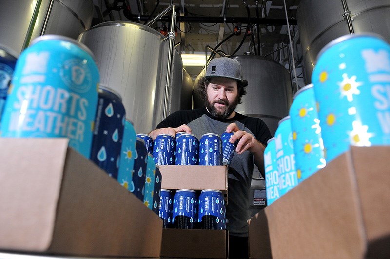 MARIO BARTEL/THE TRI-CITY NEWS
Dan Webster, of Moody Ales, organizes cans of the brewery's new Shorts Weather ISA and Still Raining dark lager that collarobated to create with West Coast Canning. Partial proceeds from sales of four-packs of the new beers go to support KidSports Tri-Cities.