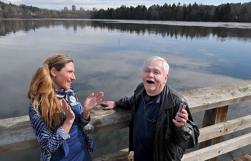 Heidi Maddrell, of the Port Moody Foundation, enjoys a spontaneous serenade by Michael Howells on the pier at Rocky Point Park on Wednesday. Maddrell said those kind of interactions help build community and are often sparked by a simple, friendly greeting. That's the premise behind the foundation's third annual Say "Hello" PoMo campaign that begins April 16.