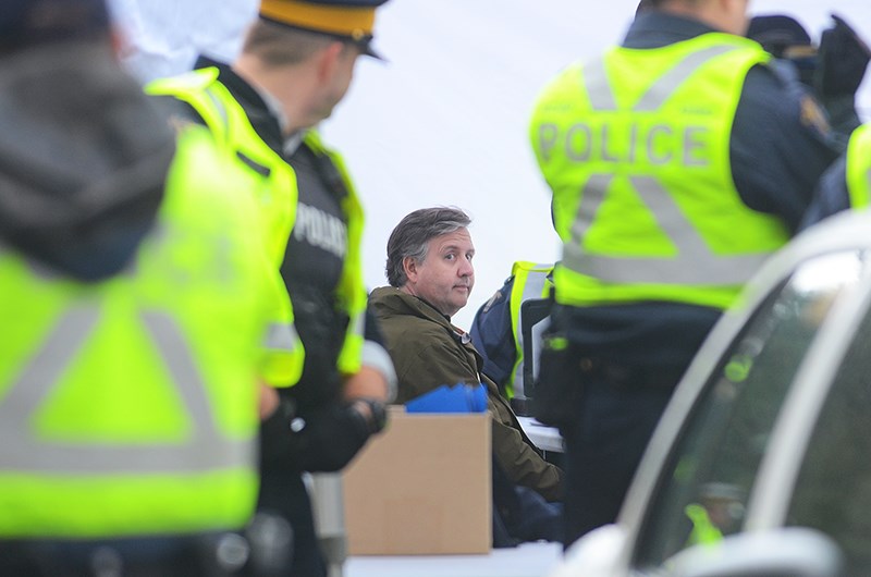 Kennedy Stewart is processed at a mobile station set up by Burnaby RCMP after being arrested outside the Trans Mountain terminal Friday afternoon.