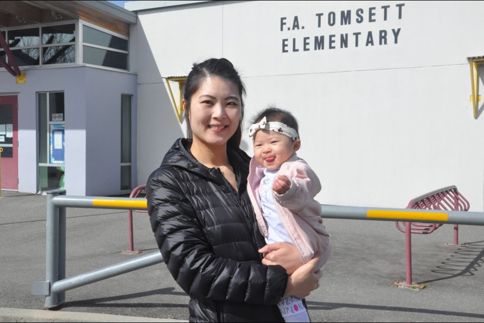 Virginia Chiu, a mom of an eight months old who moved to her current home four years ago for its proximity to Tomsett Elementary School, said she might have to consider moving if the policy remains unchanged. Daisy Xiong photo