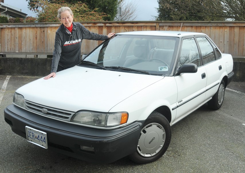 West Vancouver resident Anne Baird poses with Squeaker, her 28-year-old old Geo Prizm. Squeaker had quite an adventure trying to find replacement hubcaps. photo Mike Wakefield, North Shore News