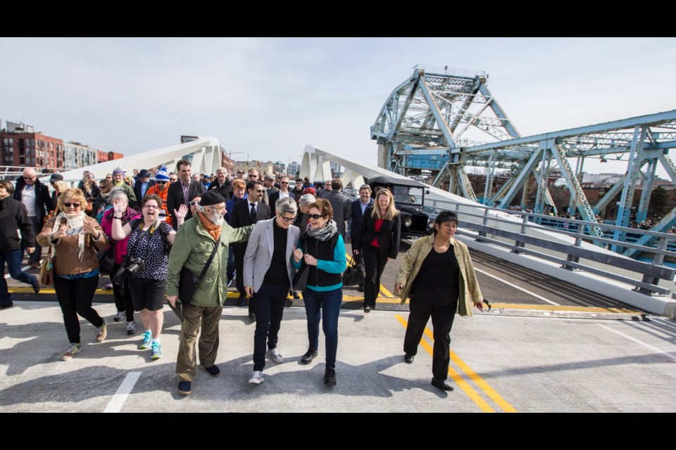 Victoria Mayor Lisa Helps, centre, joins a large crowd for the first crossing of the new Johnson Street Bridge on Saturday, March 31, 2018.