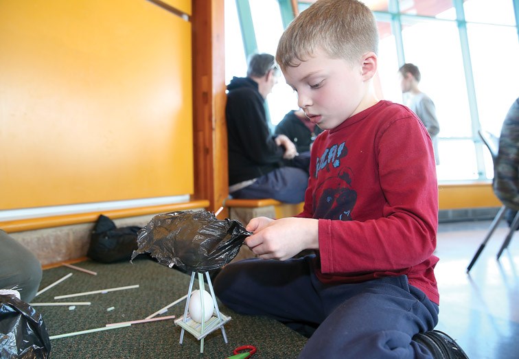 Tristain Beam, 7, meticulously builds an egg contraption during The Exploration Place's Second Annual Easter Egg Drop on Sunday afternoon. Citizen Photo by James Doyle