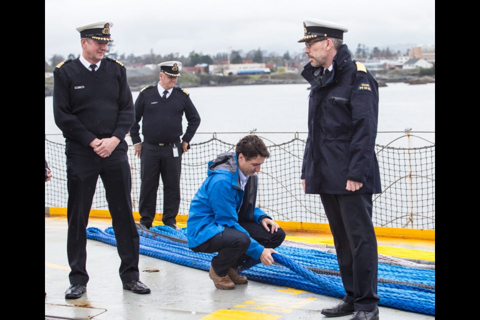 Prime Minister Justin Trudeau works the rope on the Sir Wilfrid Laurier at the Canadian Coast Guard Regional Operations Centre, Pacific Region, on Thursday, April 5, 2018.