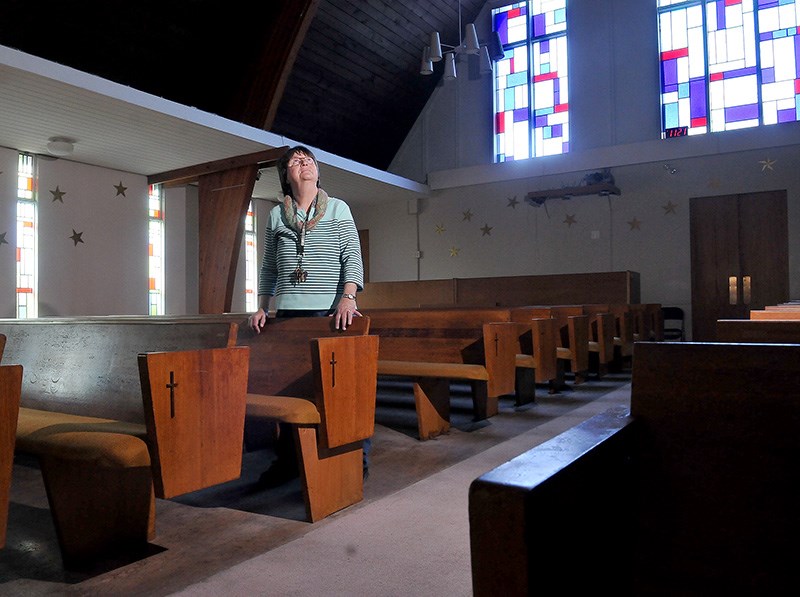 MARIO BARTEL/THE TRI-CITY NEWS
Valerie Simpson, who's in charge of organizing all the items Como Lake United Church is selling on Saturday to prepare for the demolition of its buildings, takes a look around the sanctuary. The pews are all for sale, although, she said, the end plates may be preserved as souvenirs for church members. Most of the stained glass will be incorporated in the new church space, which will be included in a new affordable rental apartment building to be constructed on the site.