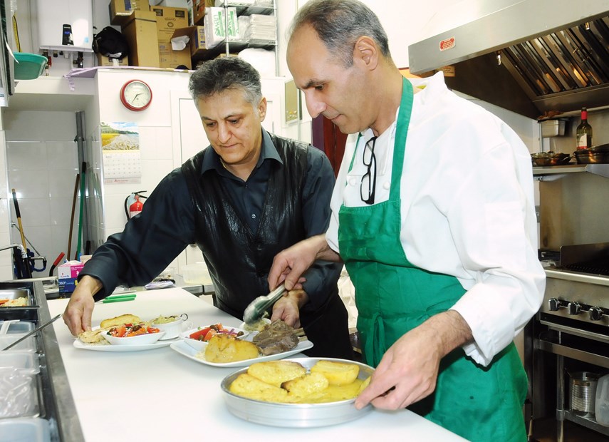 Chef/owner Mike Sarbakhteh and sous chef Cyrus Pakzad prepare traditional Greek dishes in the kitchen at Kostas Mediterranean at 751 Lonsdale Ave., North Vancouver.