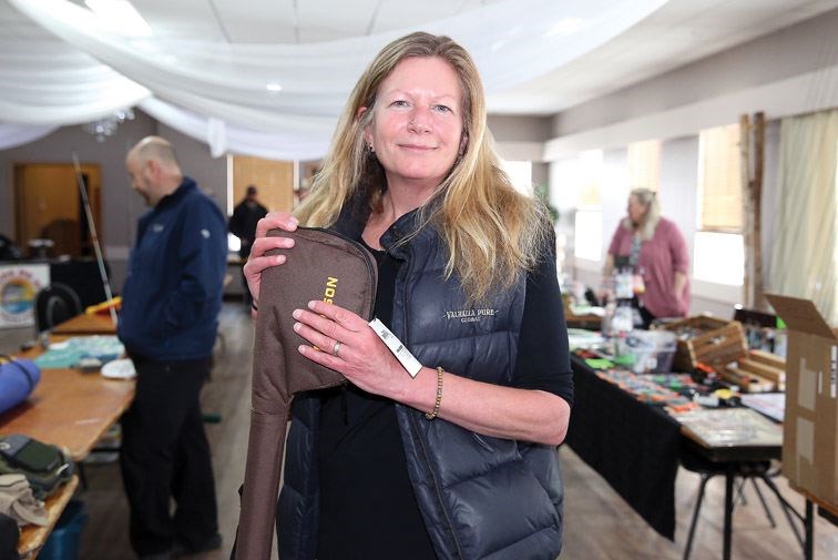 Sandy Galletti shows off her purchase at the Fishing and Hunting Swap and Sale at Columbus Hall on Sunday morning. The Gear for a Cure was a fundraiser for the BC Cancer Agency.