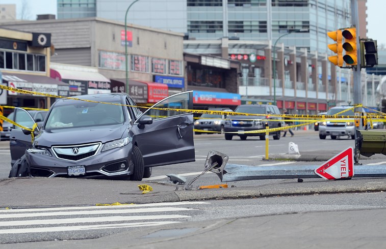 A smashed car is surrounded by police tape near Metropolis at Metrotown mall, where a pedestrian was struck by a car Monday afternoon.