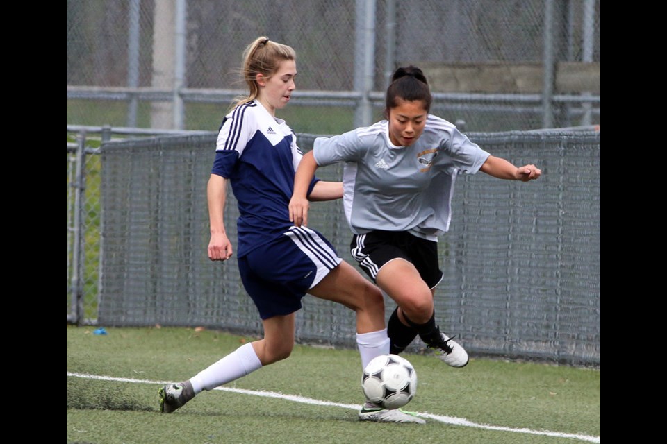 Riverside Rapids defender Taya Schubert marks Gleneagle Talons' Kelly Miada in the first half of their Fraser Valley North high school senior girls soccer match, Monday at Gates Park. Riverside won the match on the first day of league play, 3-1. Grade 9 forward Kelsey Stewart scored all three of Riverside's goals. Other results: Dr. Charles Best 8 Port Moody 0; Centennial 6 Thomas Haney 0; Terry Fox 4 Heritage Woods 4.