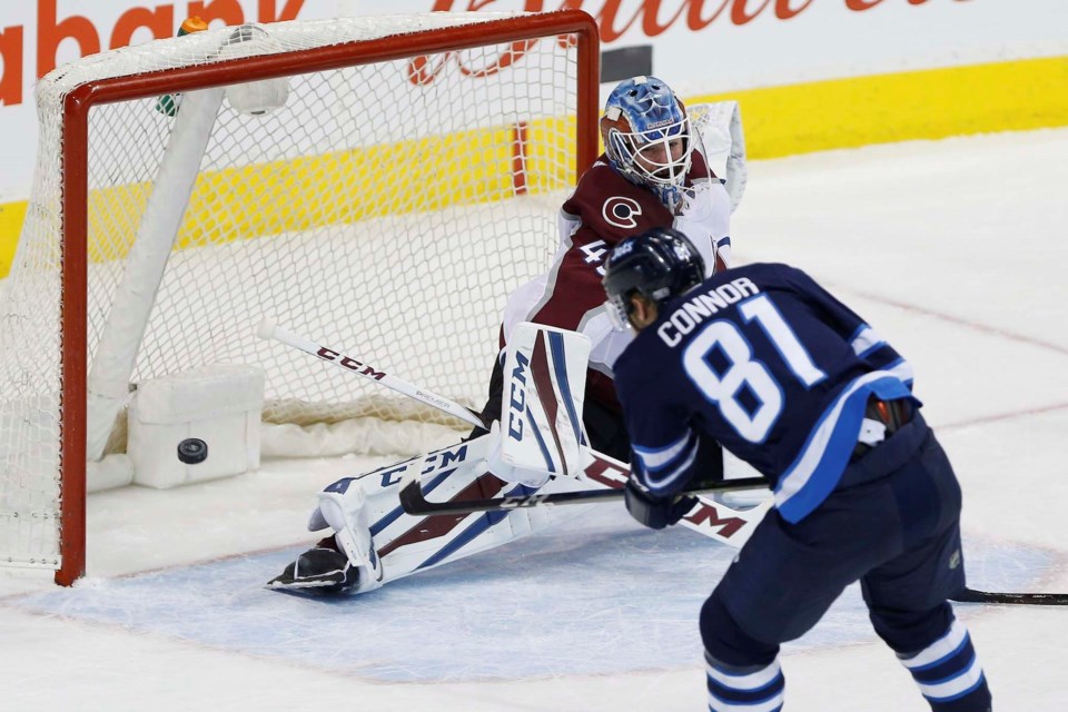 Kyle Connor of the Winnipeg Jets scores on Jonathan Bernier of the Colorado Avalanche.