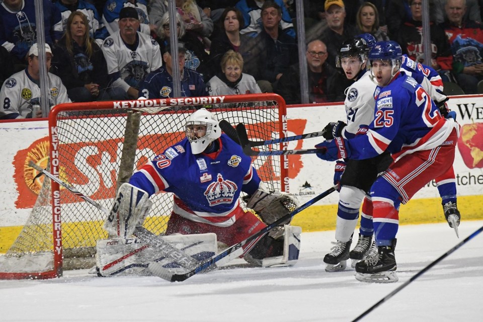 Prince George Spruce Kings forward Sam Anzai fends off Wenatchee Wild forward Sam Hesler while they watch the play develop around Kings goalie Evan DeBrouwer during Game 1 action in the BCHL Fred Page Cup championship Friday night in Wenatchee, Wash., The Wild waltzed to a 4-0 victory.