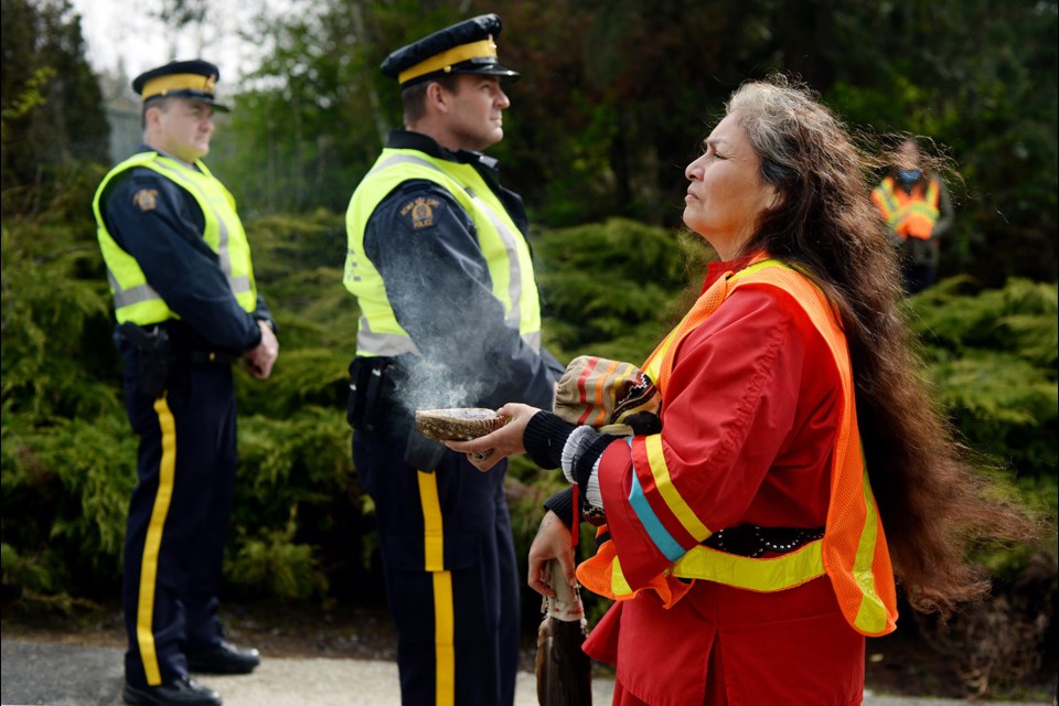 Cynthia Myran burns sage at the protests outside the Trans Mountain terminal.