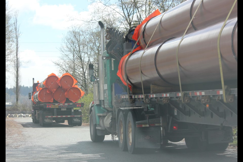 Truckloads of pipes arrive at Kinder Morgan’s staging facility in New Westminster on April 12. Additional pipe shipments were spotted Monday.