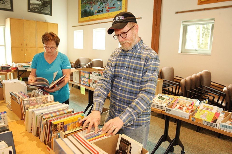Doriana Kiland and Randy Main browse the selection of books at the Friends of the Library book sale at the Squamish Public Library.