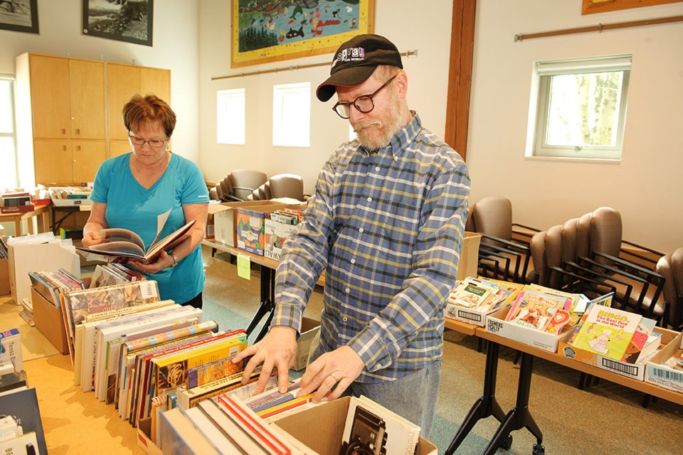 Doriana Kiland and Randy Main browse the selection of books at the Friends of the Library book sale at the ߣPublic Library.