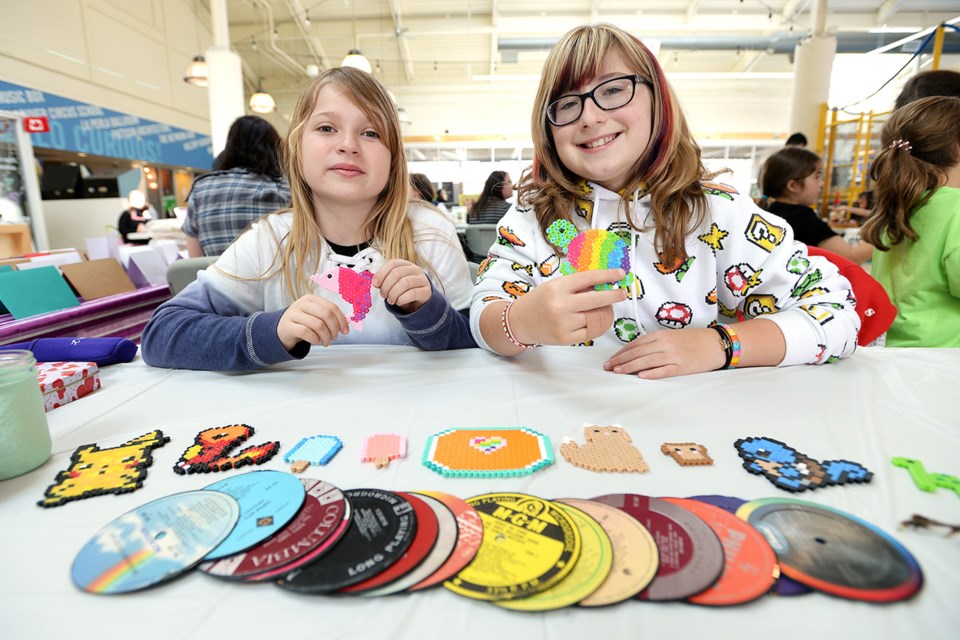 Harper Myrskog, 10, and Anni Nichiporik, 9, sell coasters and perler bead creations at the third annual F.W. Howay Elementary School spring fair.
