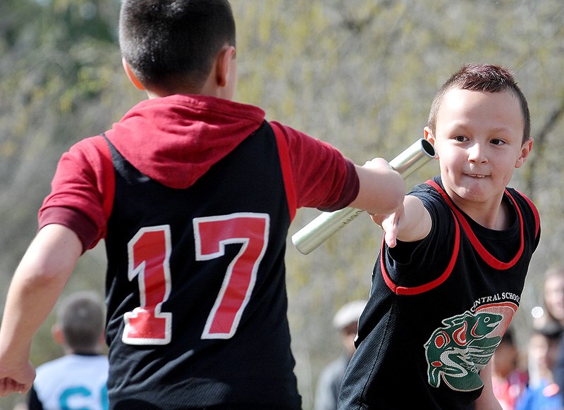 MARIO BARTEL/THE TRI-CITY NEWS
It takes concentration and focus to get the hand off right at Wednesday's Como Lake Relays.