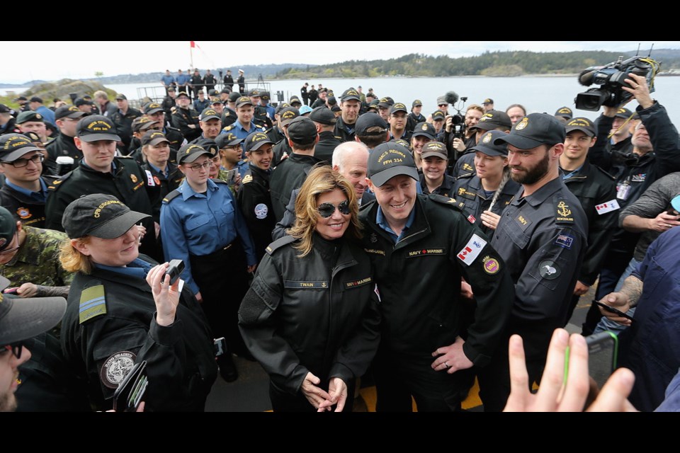 Canadian music star Shania Twain mingles with members of the Canadian Armed Force on the flight deck of HMCS Ottawa at CFB Esquimalt on Thursday, April 19, 2018.