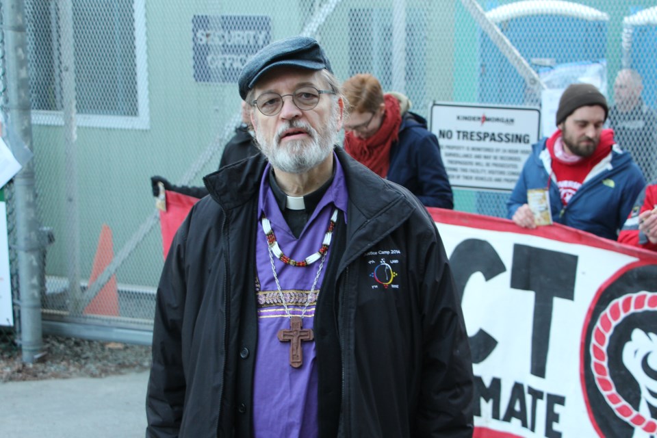 National Anglican Indigenous Bishop Mark MacDonald stands at the entrance to the Westridge Marine terminal Friday morning.