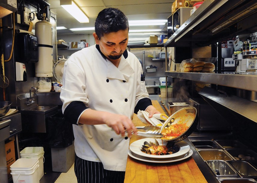 Chef Jay Kazsh plates a dish in the Cheshire Cheese kitchen.