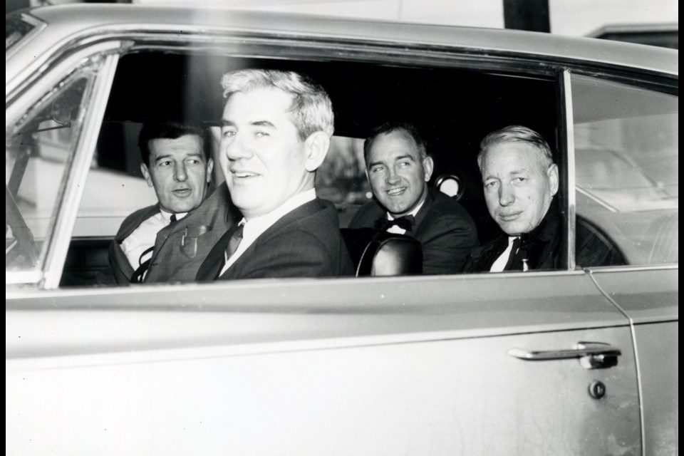 Trade unionists Paddy Neale (front passenger), Art O’Keeffe and Jeff Power (right) appear relaxed as they are driven to court by a smiling Syd Thompson, president of the IWA’s Vancouver local. The three expected to be jailed for defying a court injunction during the Lenkurt dispute, and they were.