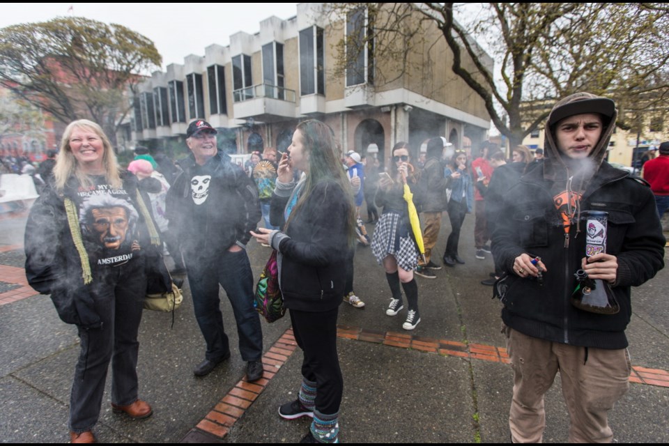 Cannabis smokers light up at 4:20 p.m. in Centennial Square in Victoria on Friday, April 20, 2018, part of a 4/20 day event.