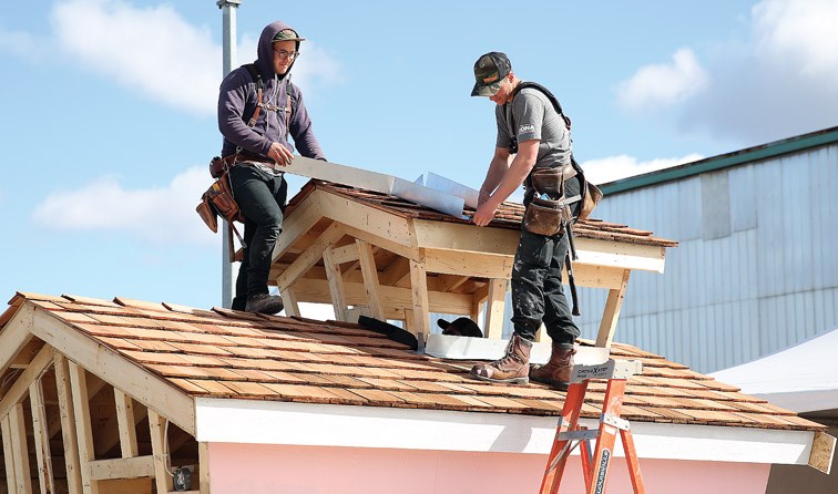 Builders work hard on the she-shed on Sunday morning at the 41st Canadian Home Builders Association Northern BC Home Show.