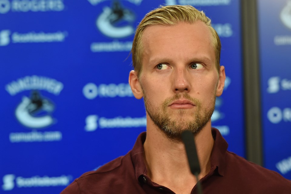 The Canucks Alex Edler looks uneasy.