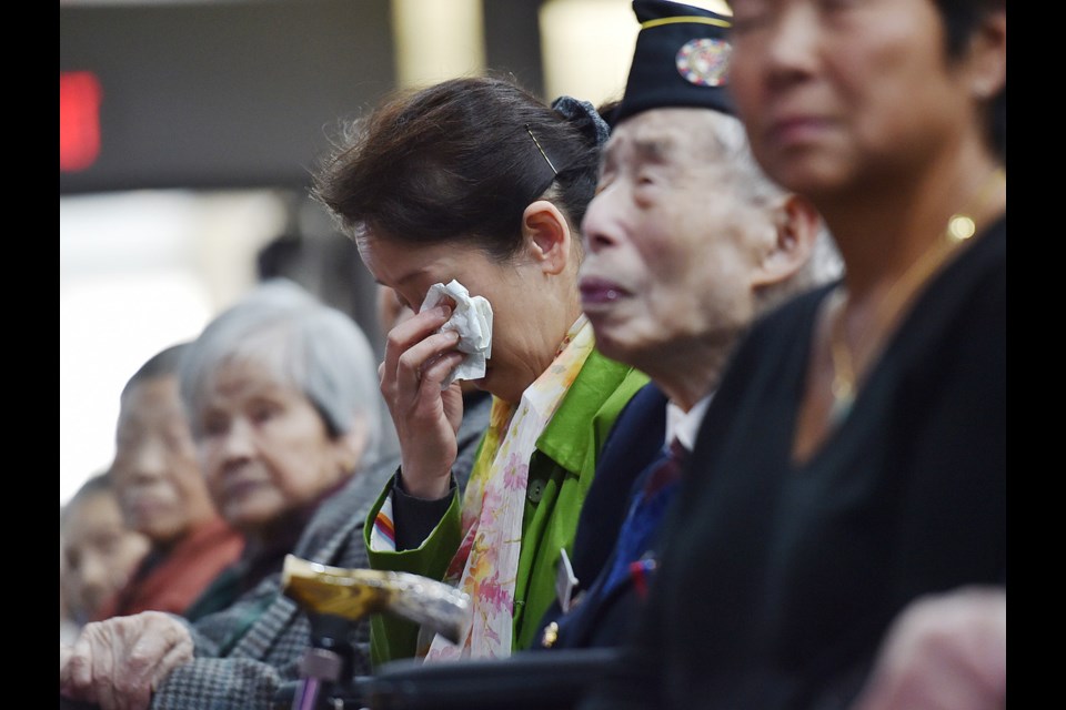 Kelley Lee, seated next to her war veteran father Monty Lee, got emotional Sunday as she listened to an apology from Mayor Gregor Robertson and two former city councillors. Photo Dan Toulgoet