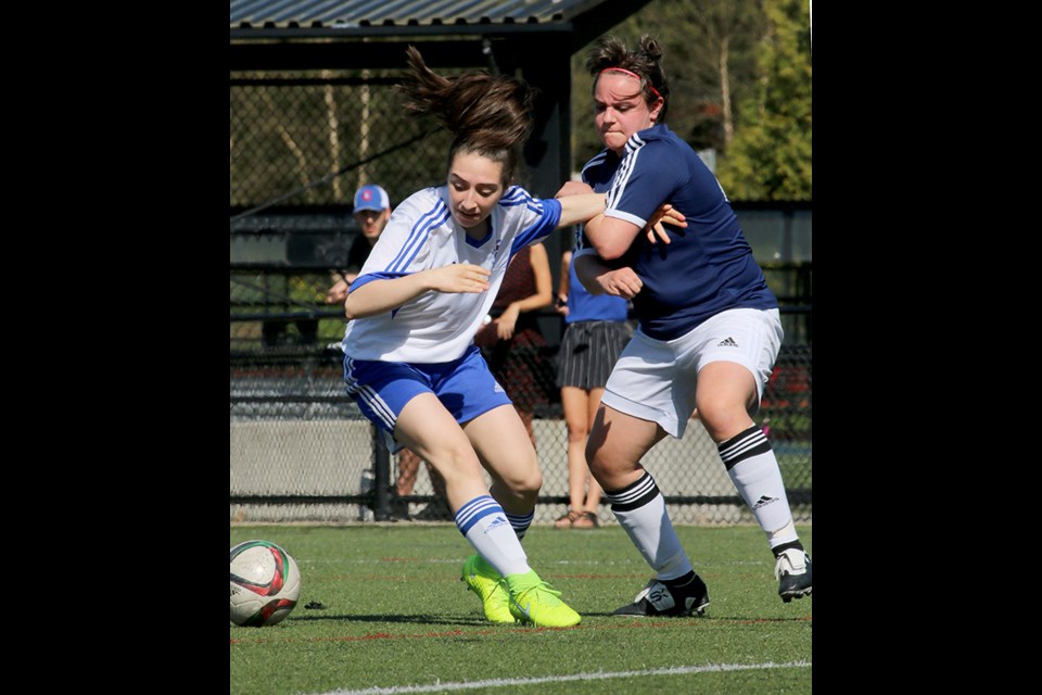 Centennial's Bianca Bettamin battles Dr. Charles Best defender Alex Redey for the ball in the first half of their Fraser Valley North senior girls high school soccer match, Wednesday at Coquitlam Town Centre Park. The eighth-ranked Centaurs beat the third-ranked Blue Devils, 2-0, on second half goals by Kiki Bowen and Raegan Mackenzie. The two teams are tied with Riverside atop the league standings. Each has five victories and a loss. The regular season wraps up on Monday.