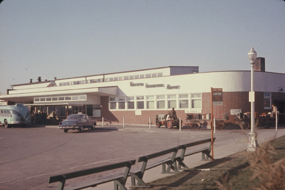 Vancouver International Airport, 1956, with baggage cart, taxi and bus. Photo: K.E. Eiche