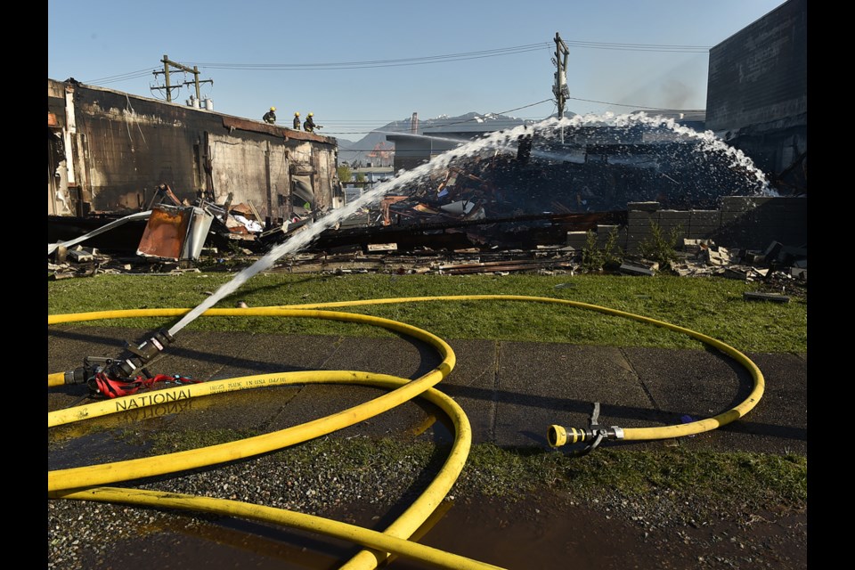 Firefighters were still on the scene Thursday morning of a fire that destroyed a building on East Pender Street. Photo Dan Toulgoet