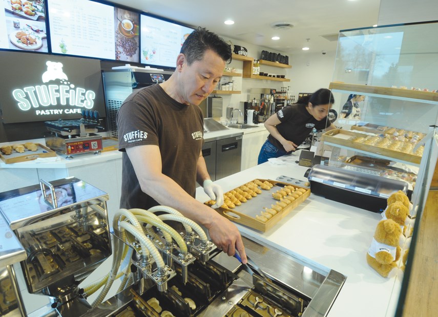 Jin Lee and wife Adie flip freshly baked pastries as they come out of the forming machine at North Vancouver’s Stuffies Pastry Café. The recently opened shop, a bright and fun little venue kitty-corner to Phibbs Exchange, specializes in creating stuffed animal shaped pastry pockets.