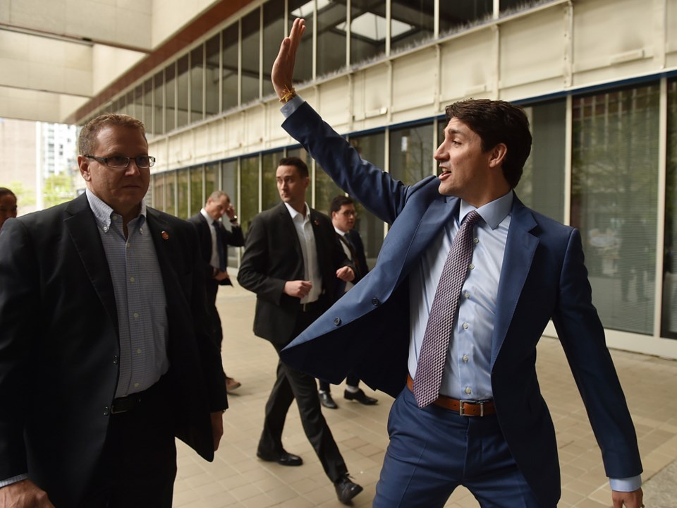 Justin Trudeau waves to protesters in Vancouver