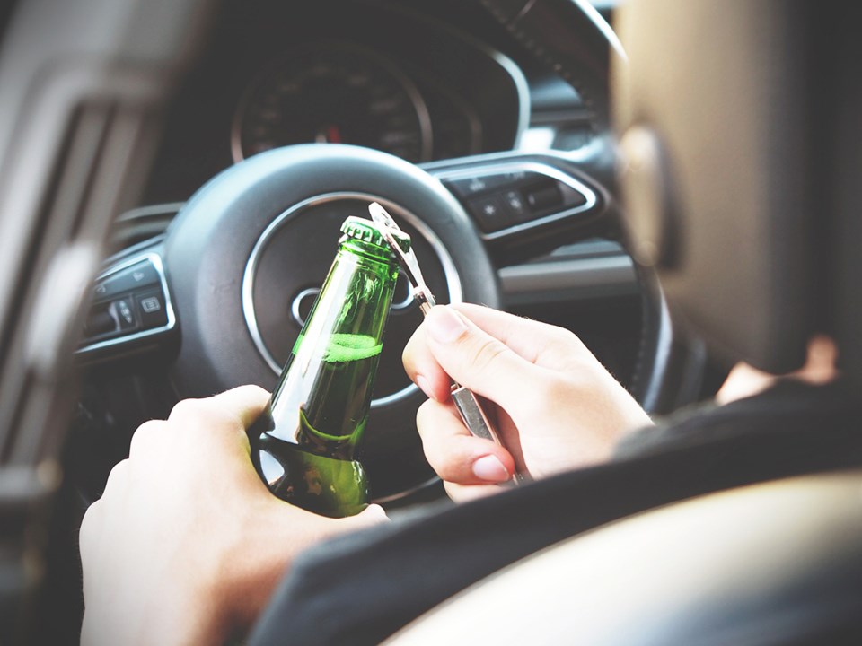 Opening a beer at the wheel.