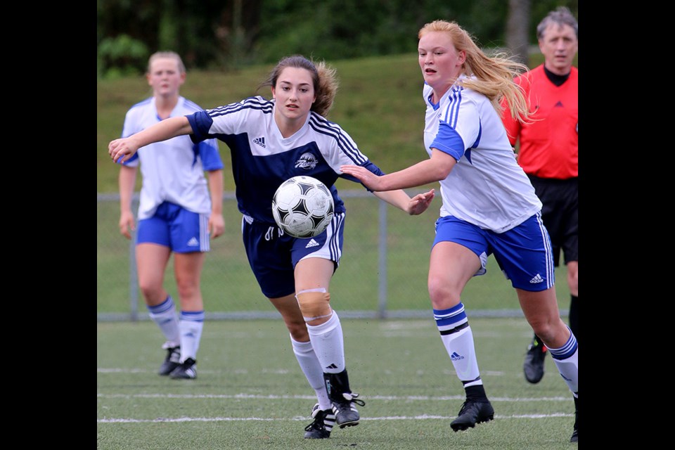 Centennial Centaurs Jessa Vance advances the ball ahead of Riverside Rapids' defender Anika Morokhovich in the first half of their quarter-final match in the Fraser Valley high school girls soccer championship tournament, Wednesday at Gates Park in Port Coquitlam. Vance scored a goal in Centennial's 2-0 victory.