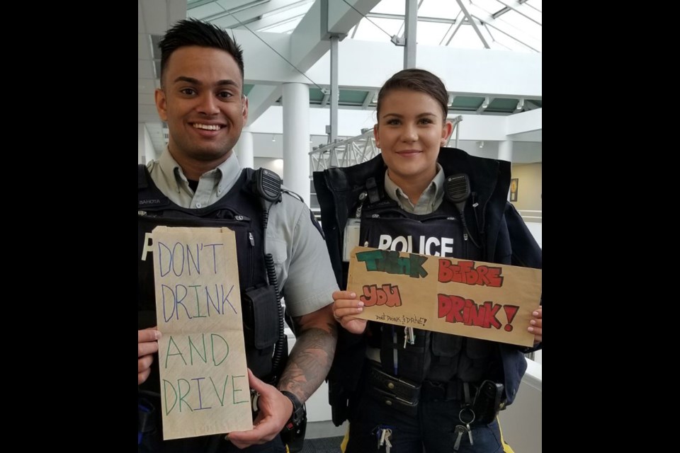 Two new members of Richmond RCMP, Constable Gudkova and Sahota, have delivered to liquor stores a series of messages written by local schoolkids. Submitted photo