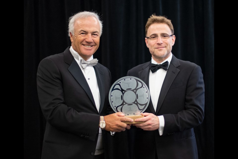 Peter Gustavson, left, and Stewart Butterfield with the Peter B. Gustavson School of Business 2018 Distinguished Entrepreneur of the Year award on Friday, May 11, 2018.