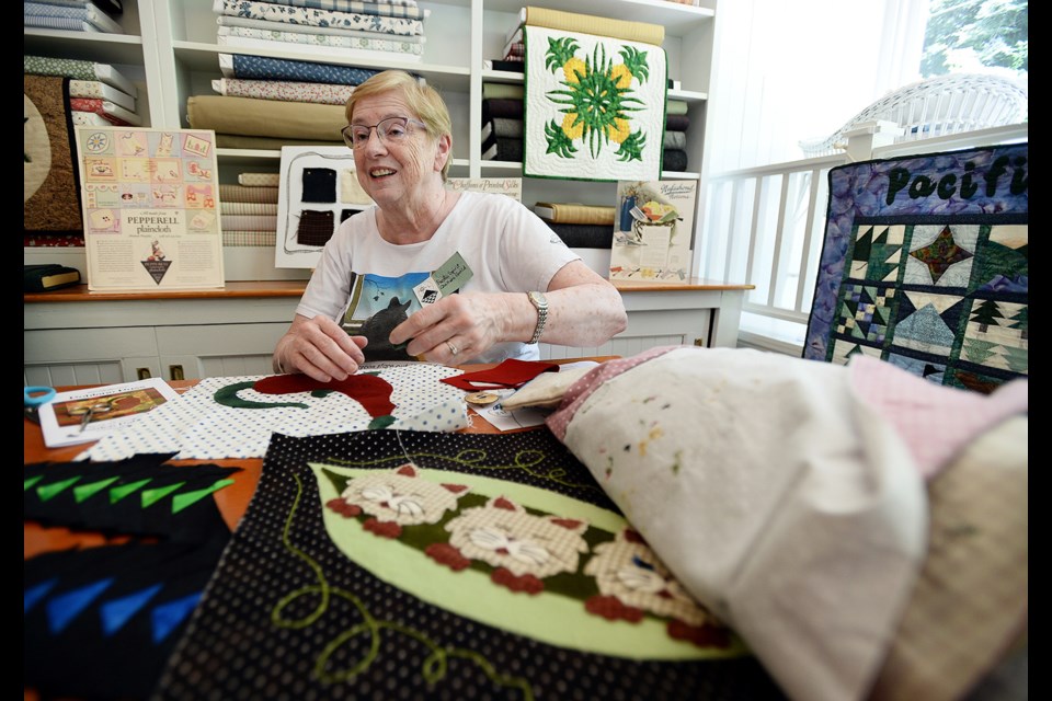 Mary Plischke of the Pacific Spirit Quilters Guild works on a project inside Bell's Dry Goods at Burnaby Village Museumon Mother's Day.