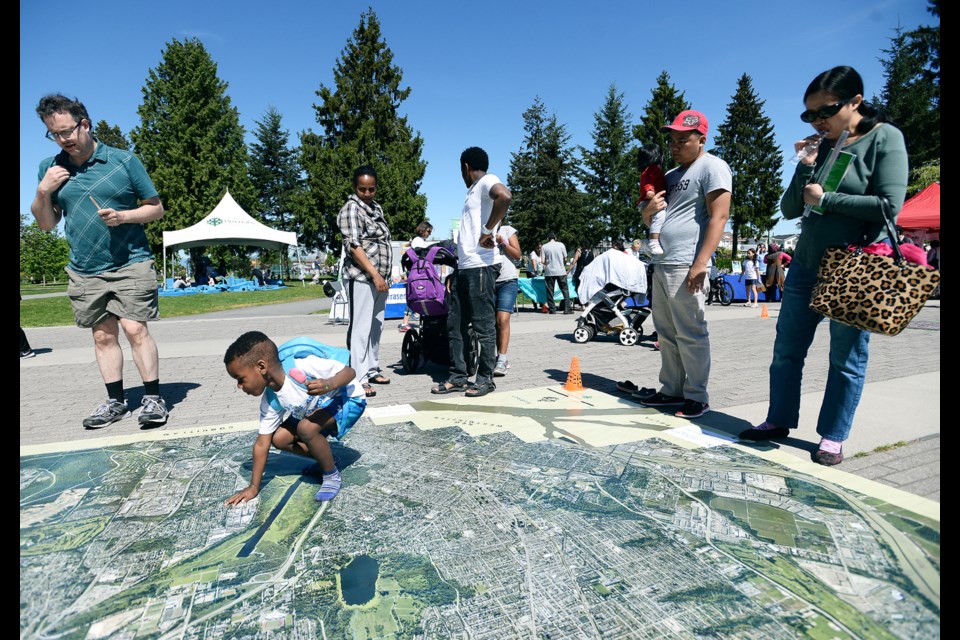 Senalder Laman looks over a map of Burnaby at the Walking Festival at Edmonds Community Centre.