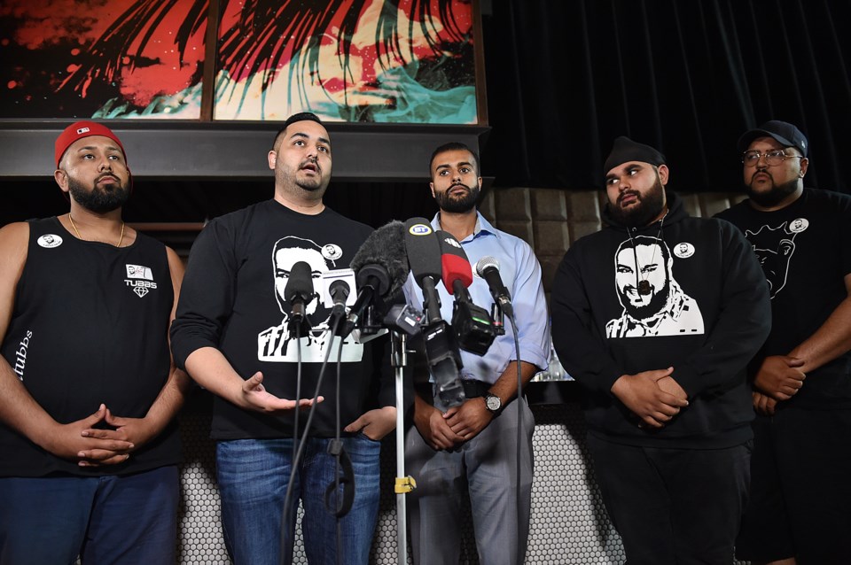 Kalwinder Thind's brother in law Simran Bhullar is flanked by friends and coworkers of Thind's who s