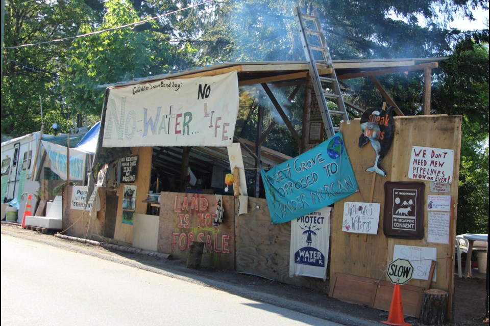 Some residents of the Forest Grove neighbourhood are asking the City of Burnaby to remove two protest camps at gates of Trans Mountain's terminal on Burnaby Mountain. Protesters parked a camper van dubbed "Camp Cloud" outside the gates of the terminal last fall. Since then, that camp has grown to include two campers, one large main structure, a cabin, and several small tents. Another structure, the "carving cabin," currently under construction.