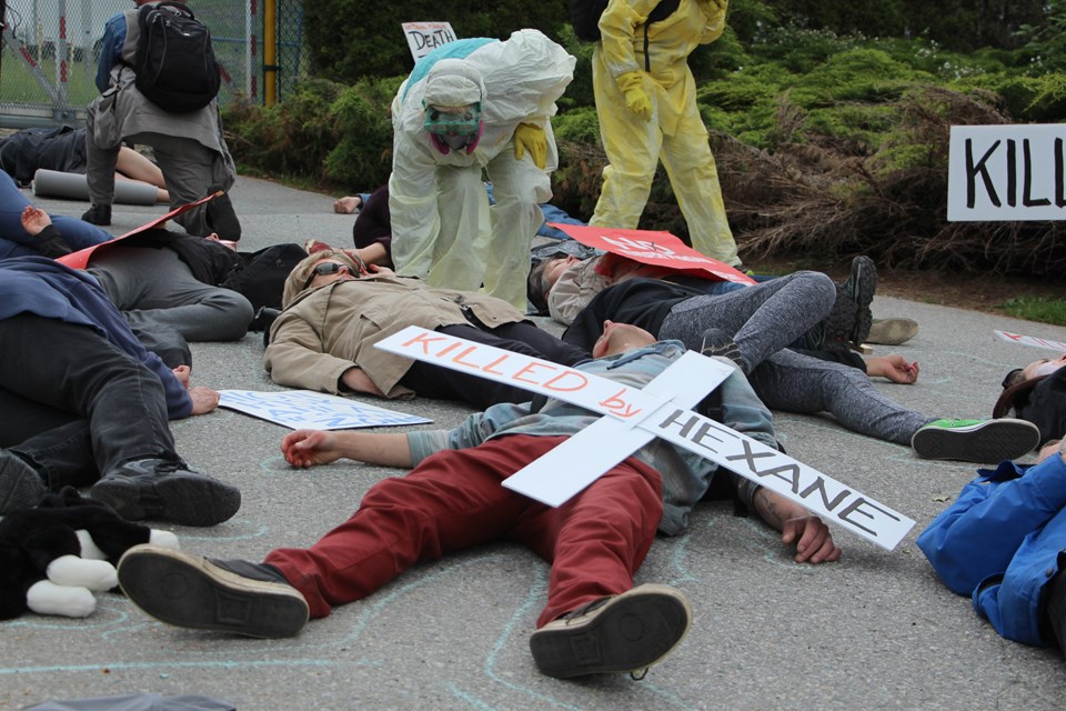 Protesters lay in front of the gates to the Trans Mountain terminal on Burnaby Mountain at a 'die-in' organized by BROKE (Burnaby Residents Opposed to Kinder Morgan Expansion), dramatising what a disaster may look like following an explosion at the tank farm. Faces were painted with fake blood, and participants held white crosses listing why they were 'killed.' Others, dressed in hazmat suits, outlined bodies in chalk before picking them up on stretchers and carrying them away.