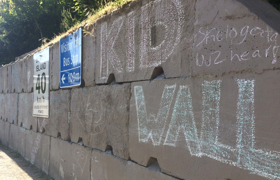 Chalk already adorns the lock-brick wall beside the ferry dock.