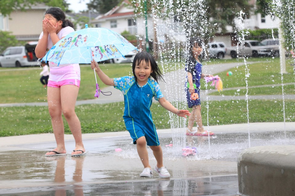 Four-and-a-half-year-old Brittany Dang tries out a little splashing at Edmonds Park.