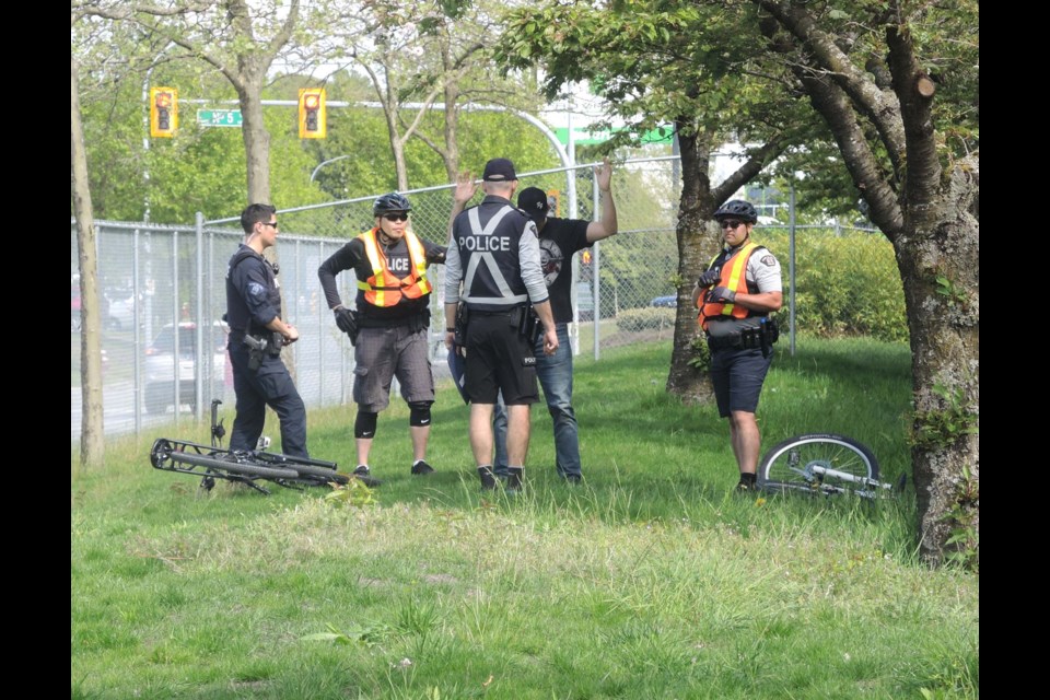 Two bike patrol candidates (hi-vis vests) arrest a "suspect" as part of their examinations in Richmond